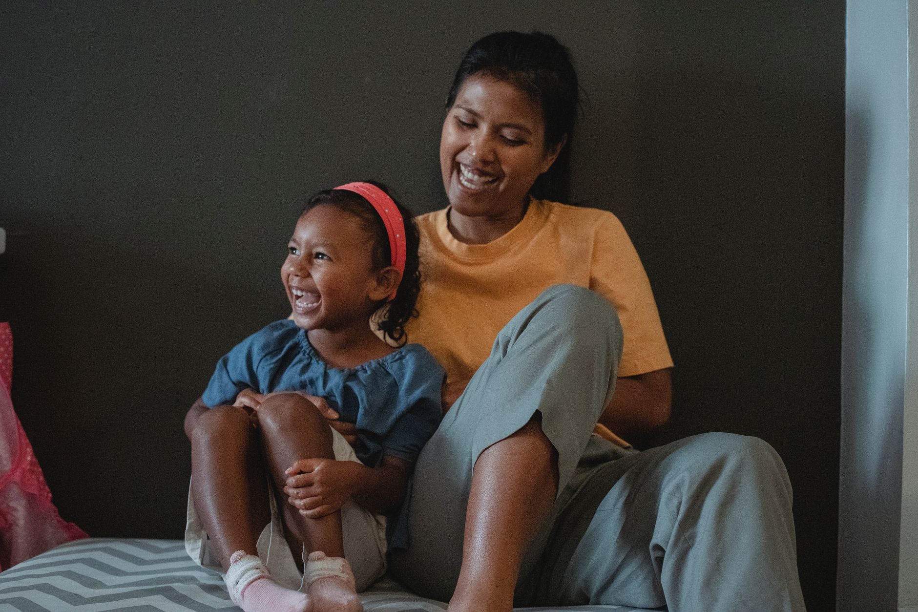 A parent and child smiling together